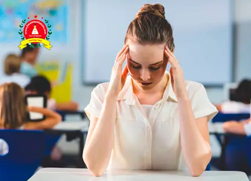 Woman experiencing stress in a classroom setting, representing the benefits of essential oils for stress and anxiety relief.